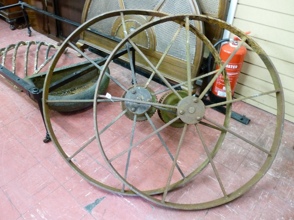 A VINTAGE PAIR OF CAST IRON HAYMAKER WHEELS with some gearing intact, 106.5 cms diameters