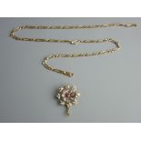 A NINE CARAT GOLD CHAIN with a pearl and ruby set pendant, 46 cms long the chain, 8.5 grms, the