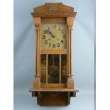 A VINTAGE OAK CASED WALL CLOCK, the gold coloured dial set with Arabic numerals and twin winding