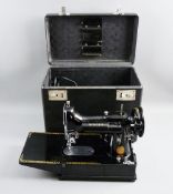 A CASED SINGER 222K SEWING MACHINE with foot pedal and a jar of attachments