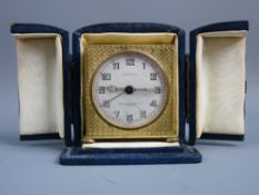 A CIRCA 1920's ZENITH TRAVEL ALARM CLOCK in blue leather fitted case, the dial set with Arabic