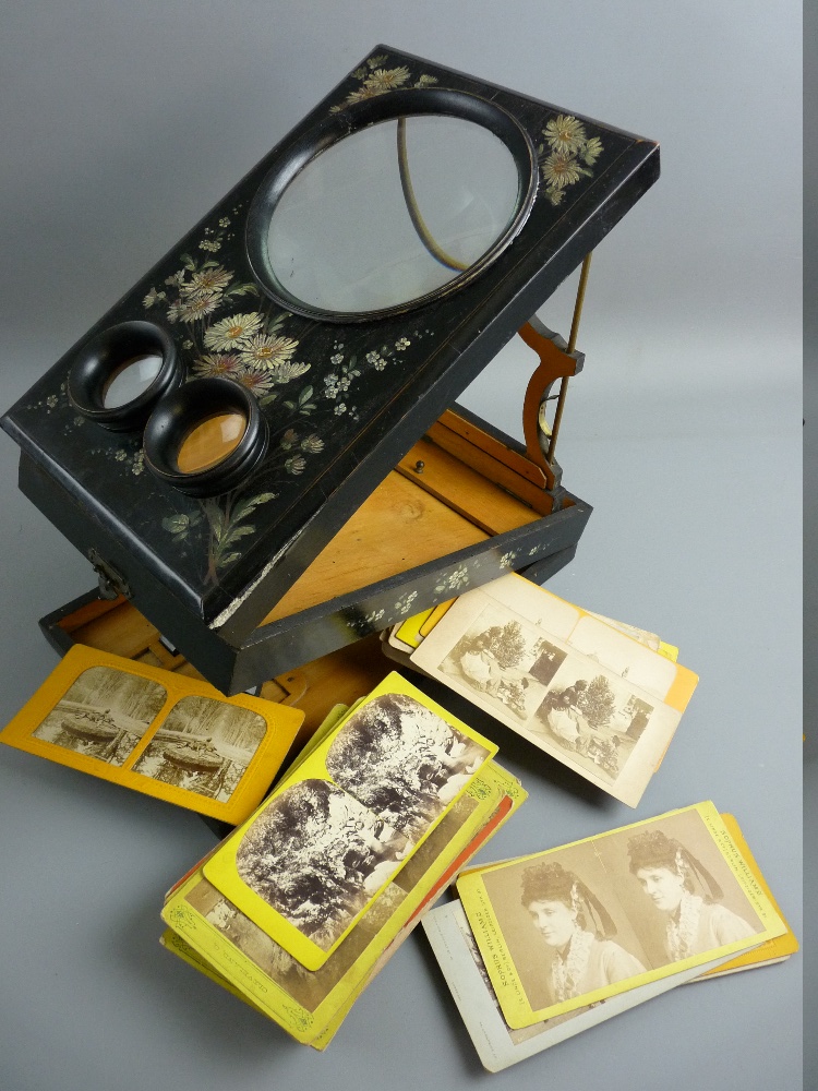 A VICTORIAN STEREOSCOPE with approximately fifty viewing cards, the black lacquered case with floral