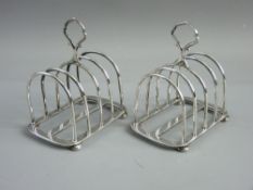 A MATCHING PAIR OF HALLMARKED SILVER TOAST RACKS by Hukin & Heath, Birmingham dates for 1921 and