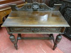 A VICTORIAN CARVED OAK SINGLE DRAWER HALL TABLE, the railback with scroll and mask carving, the