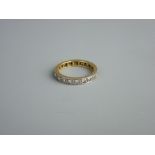 AN EIGHTEEN CARAT GOLD & PLATINUM ETERNITY RING, 3.3 grms