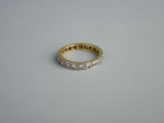 AN EIGHTEEN CARAT GOLD & PLATINUM ETERNITY RING, 3.3 grms