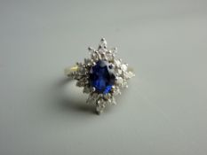 AN EIGHTEEN CARAT GOLD TANZANITE & DIAMOND DRESS RING having a centre oval blue stone with