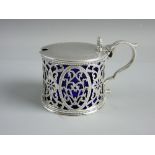 A HALLMARKED SILVER LIDDED MUSTARD POT by Henry Holland, the decorated lid with shell shaped thumb