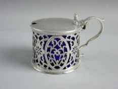 A HALLMARKED SILVER LIDDED MUSTARD POT by Henry Holland, the decorated lid with shell shaped thumb