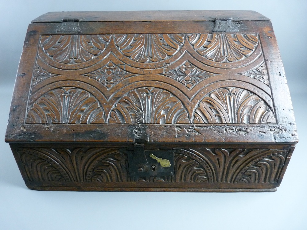 A CIRCA 1750 OAK BIBLE BOX & CONTENTS, with iron clasp lock and hinges, the sloped front with chip