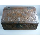 A CIRCA 1750 OAK BIBLE BOX & CONTENTS, with iron clasp lock and hinges, the sloped front with chip