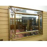 A REPRODUCTION REGENCY STYLE PIER MIRROR, the bevelled edge glass set in a double frame with pierced