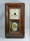 A WALNUT CASED AMERICAN WALL CLOCK by Waterbury Clock Co, the dial set with Roman numerals and