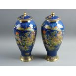 A PAIR OF CARLTONWARE BLUE ROYALE BALUSTER VASES with covers, with typical enamel and gilt