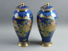 A PAIR OF CARLTONWARE BLUE ROYALE BALUSTER VASES with covers, with typical enamel and gilt