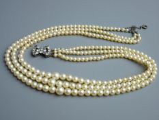 A TRIPLE STRAND CIRO PEARL NECKLACE, boxed