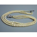 A TRIPLE STRAND CIRO PEARL NECKLACE, boxed