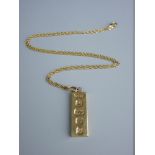 A NINE CARAT GOLD OBLONG INGOT with fine link chain, total 17.5 grms