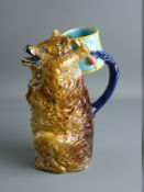 A JOSEPH HOLDCROFT ENGLISH MAJOLICA BEAR JUG, modelled on his haunches, his arms raised behind his
