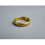 A TWENTY TWO CARAT GOLD WEDDING BAND, 9 grms