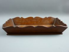 A SMALL MAHOGANY DEEP SIDED TRAY of rectangular form with shaped top decoration, 6 cms high, 32