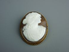 A FIFTEEN CARAT GOLD MOUNTED CARVED SHELL CAMEO BROOCH of a classical Greek style head and shoulders