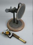 A VINTAGE MONOCULAR SCOPE ON STAND with multi-swivel action and pointers (possibly for calibrating