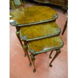 AN EXCELLENT NEST OF THREE BURR WALNUT SIDE TABLES, the shaped tops with carved oyster shell