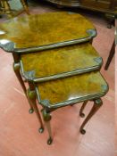 AN EXCELLENT NEST OF THREE BURR WALNUT SIDE TABLES, the shaped tops with carved oyster shell