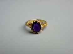 A NINE CARAT GOLD & PURPLE SAPPHIRE RING, the 10 mm oval cut stone in a crown style setting and