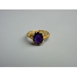 A NINE CARAT GOLD & PURPLE SAPPHIRE RING, the 10 mm oval cut stone in a crown style setting and