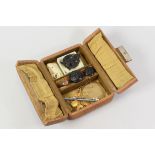 A VINTAGE CENTRE-OPENING JEWELLERY BOX & CONTENTS including 15ct and 9ct safety-pins etc