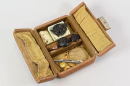 A VINTAGE CENTRE-OPENING JEWELLERY BOX & CONTENTS including 15ct and 9ct safety-pins etc