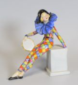 RARE WADE FIGURE OF A HARLEQUIN GIRL perched on a plinth with tambourine and wearing a blue
