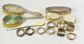A PARCEL OF NINE SILVER NAPKIN RINGS, 4.5ozs together with five silver backed brushes etc