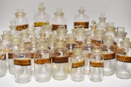 APPROXIMATELY 38 CLEAR ANTIQUE GLASS PHARMACEUTICAL JARS with labels, various sizes