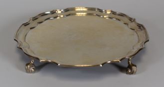 AN ELIZABETH II SILVER SALVER with crimped and stepped gallery-rim with four scroll feet, Birmingham