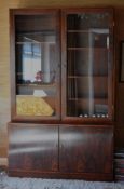 A ROSEWOOD CUPBOARD / CABINET the cupboard base of two doors below the upper glazed cabinet doors