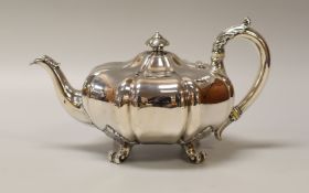 AN EARLY VICTORIAN MELON SHAPED SILVER TEAPOT on four scrolled acanthus supports, acanthus handle