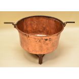 A LARGE ANTIQUE COPPER PAN on metal stand, the copper with riveted reinforcement and iron loop