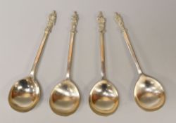A SET OF FOUR SILVER LADLES with robed apostles to the terminal, marks for Elkington & Co Ltd,