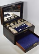 A COROMANDEL VANITY BOX WITH FITTED SILVER CONTENTS bearing maker's label for Stocken & Co, the