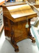 A VICTORIAN WALNUT DAVENPORT DESK having a concealed bank of four drawers to the side and with