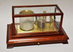 A REPRODUCTION BAROGRAPH by Russell of Norwich in a wood and glass case, 39 cms wide at base
