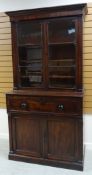 AN EMPIRE MAHOGANY SECRETAIRE BOOKCASE composed of base two-door cupboard and fold down drawer to