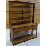 A NINETEENTH CENTURY PITCH PINE WELSH DRESSER having an open base raised on six corner supports with