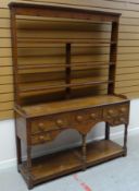 A NINETEENTH CENTURY PITCH PINE WELSH DRESSER having an open base raised on six corner supports with