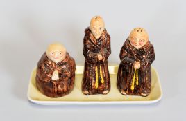 A CARLTONWARE NOVELTY CRUET SET IN THE FORM OF THREE MONKS on a conforming dish, impressed 2845