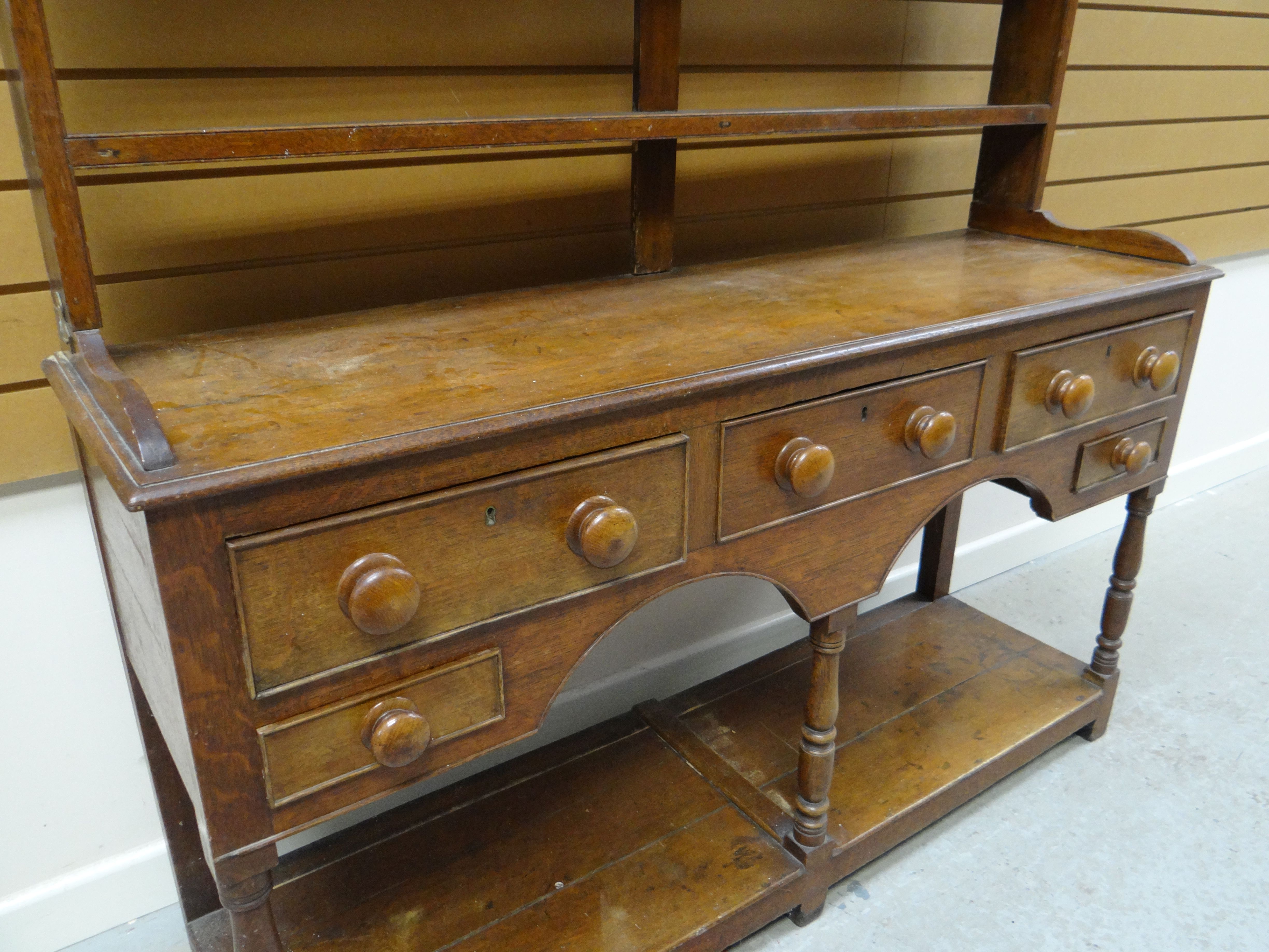 A NINETEENTH CENTURY PITCH PINE WELSH DRESSER having an open base raised on six corner supports with - Image 2 of 2