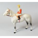 A BESWICK RACEHORSE & MOUNTED JOCKEY the horse in dappled grey, the rider in blue and green silks